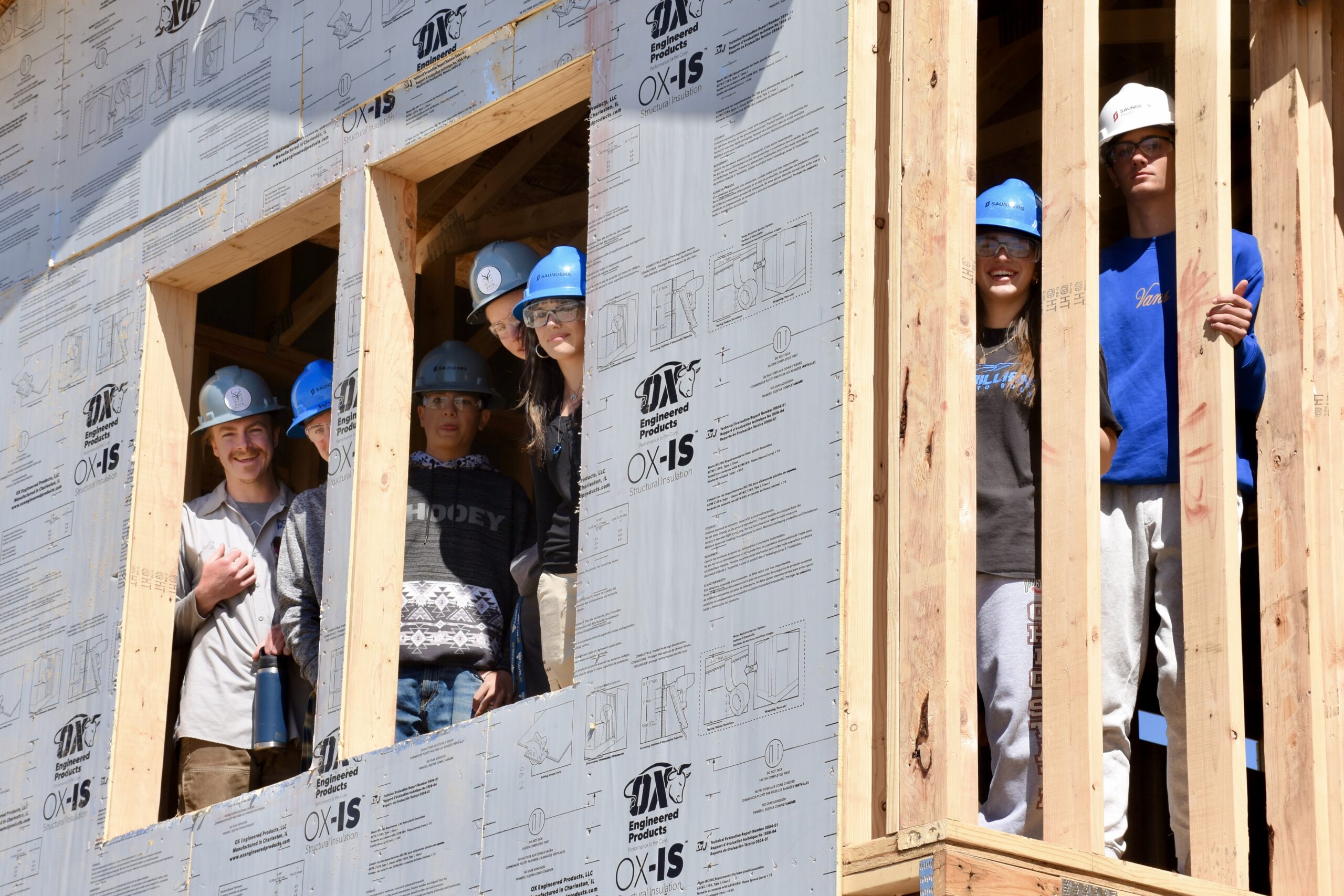 Students framing a wall on a construction site